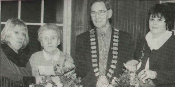 Photograph: (L-R) Maura McKeever and her mother Maisie Rooney and Margaret English receive bouquets of flowers from Pearse O'Hanrahan, Chairman of Dundalk UDC, at the unveiling of a memorial plaque in memory of their love ones who were killed in the bombing of Dundalk.