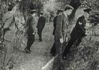 Plain clothes detective John Courtney, Dublin Murder Squad, pictured second from right, with other detectives and uniformed Gardai in the lane where Seamus Ludlow was murdered. The photograph dates from the day after the crime was committed.