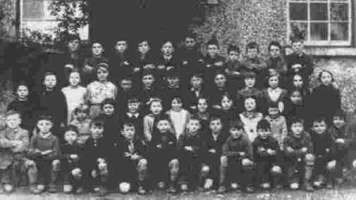 Photograph: Here, a very young Seamus Ludlow is seen in a group photograph of children taken at Faughart National School, in the late 1930s. Seamus is third from extreme right in the top row. His sister Kathleen can also be seen, second from left in the second row.