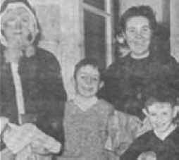 Photograph: In this newspaper photograph, Seamus Ludlow, the innocent victim of Loyalist/UDR assassins appears dressed as Santa Claus. He is pictured with his sister-in-law Mrs. Kitty Ludlow, now deceased, and her sons Peadar and Brendan.
