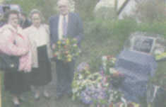 Two of Seamus Ludlow's sisters and a brother lay a wreath at the memorial.